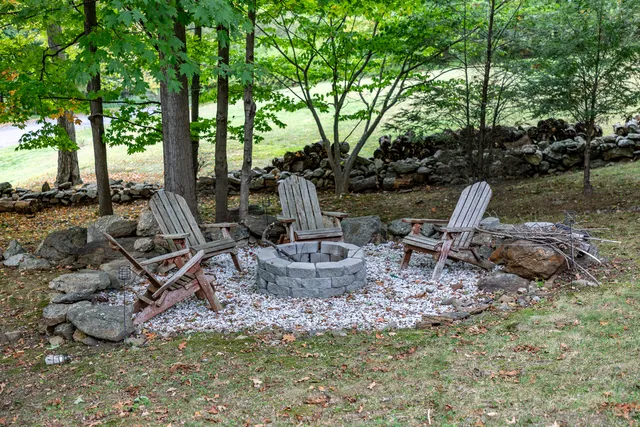 a view of a backyard with sitting area and garden