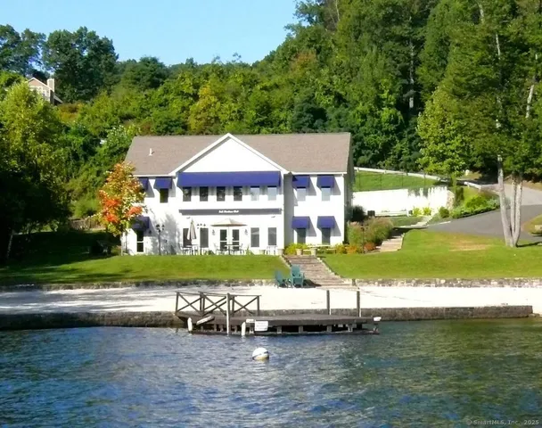 a blue swimming pool is sitting in front of a house