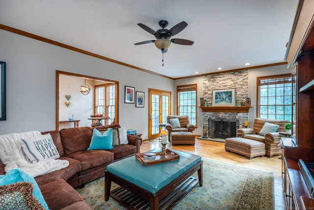 a living room with furniture a table and a large window