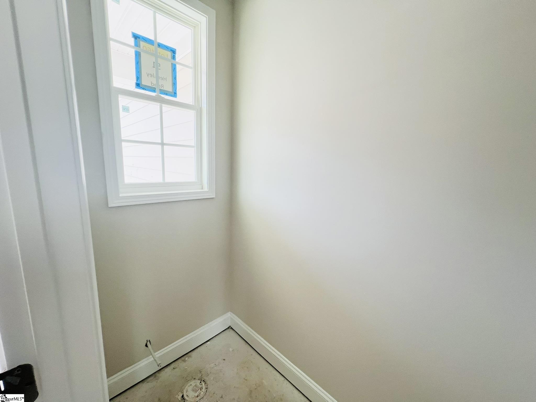 51 Hensley Road, Unit SITE 60 Greenville, SC 29607 - Photo 8 of 31 A thoughtfully designed entry with hardwood flooring and crown molding sets a warm, elegant tone as you step inside. Positioned just off the powder room and leading directly into the open-concept living space, it’s both welcoming and functional.