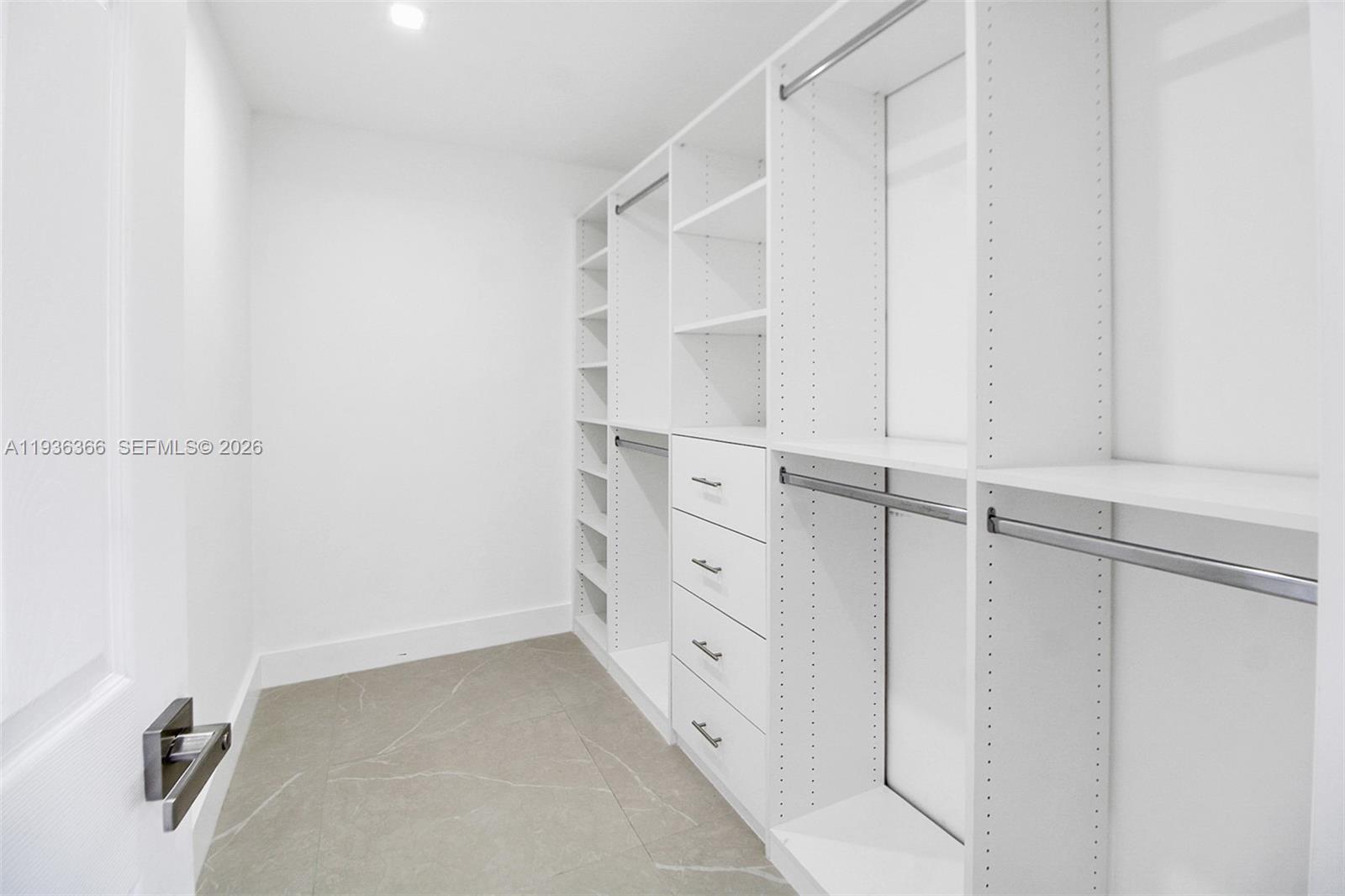 7904 Southwest 139th Court Miami, FL 33183 - Photo 11 of 33 a view of walk in closet with empty racks