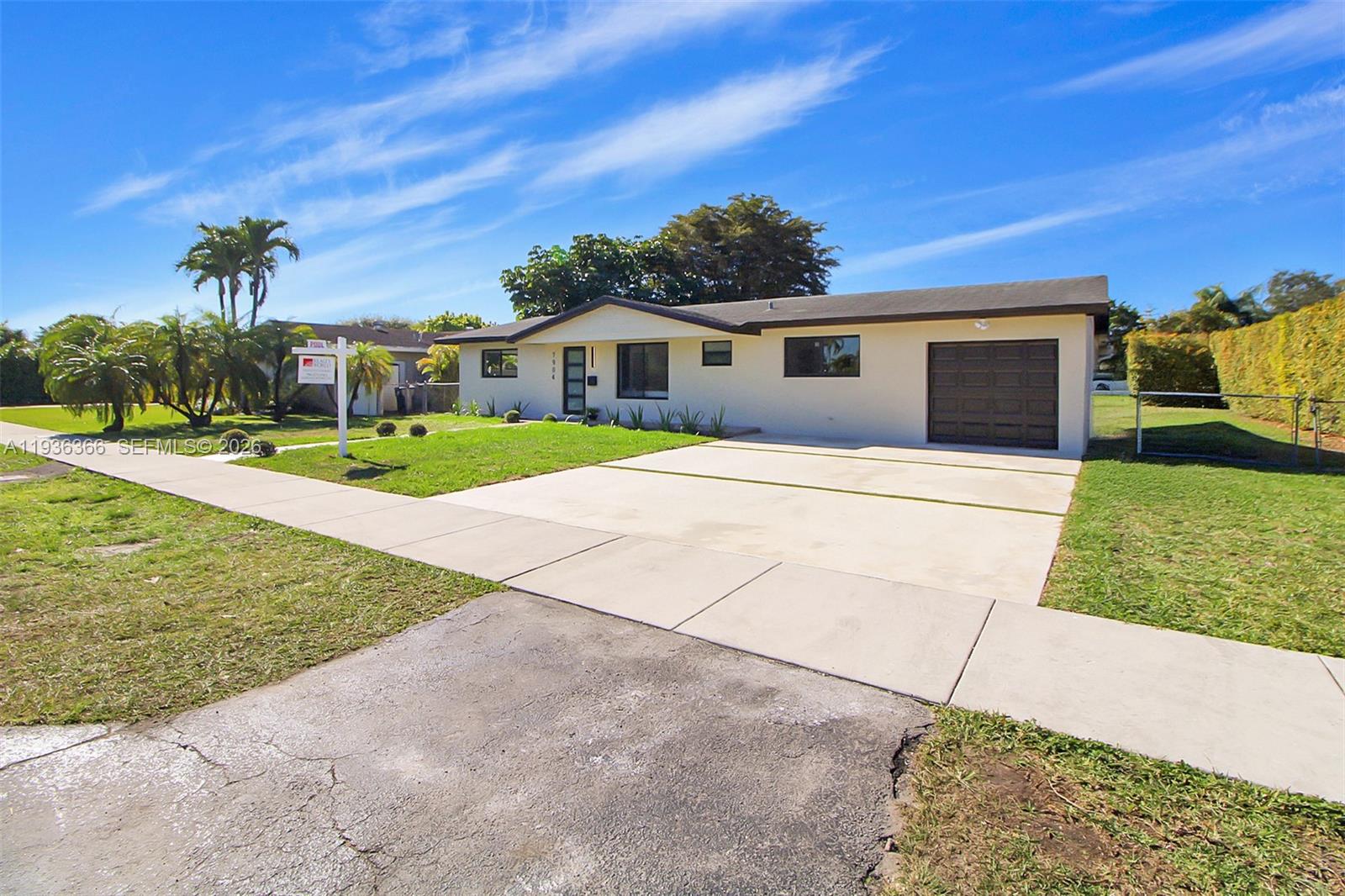 7904 Southwest 139th Court Miami, FL 33183 - Photo 20 of 33 a front view of a house with a yard and potted plants