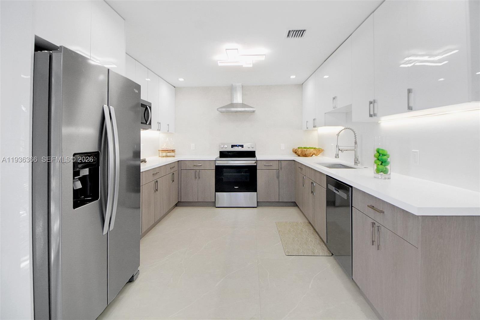 7904 Southwest 139th Court Miami, FL 33183 - Photo 2 of 33 a kitchen with stainless steel appliances a refrigerator sink and cabinets