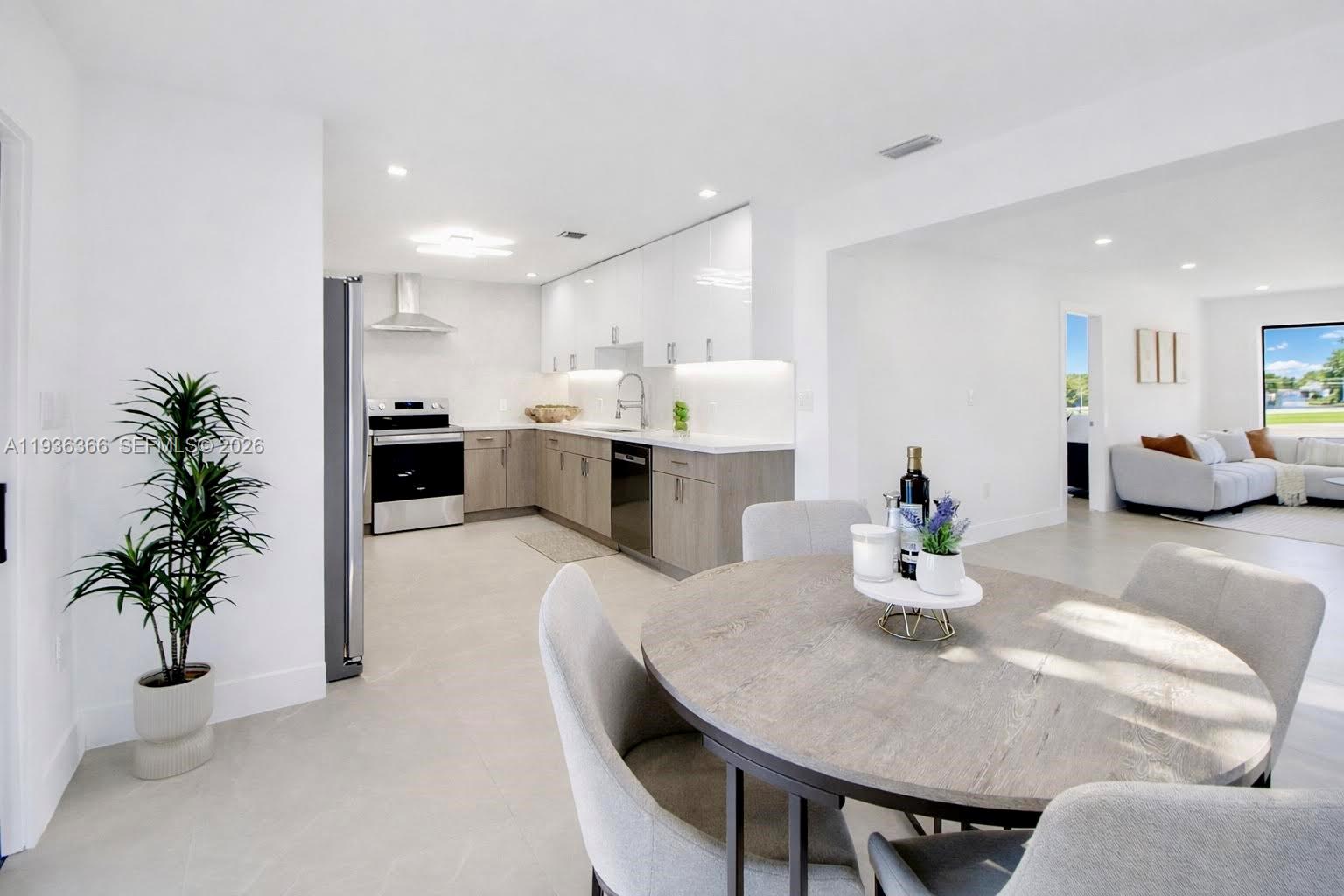 7904 Southwest 139th Court Miami, FL 33183 - Photo 7 of 33 a kitchen with a table and chairs