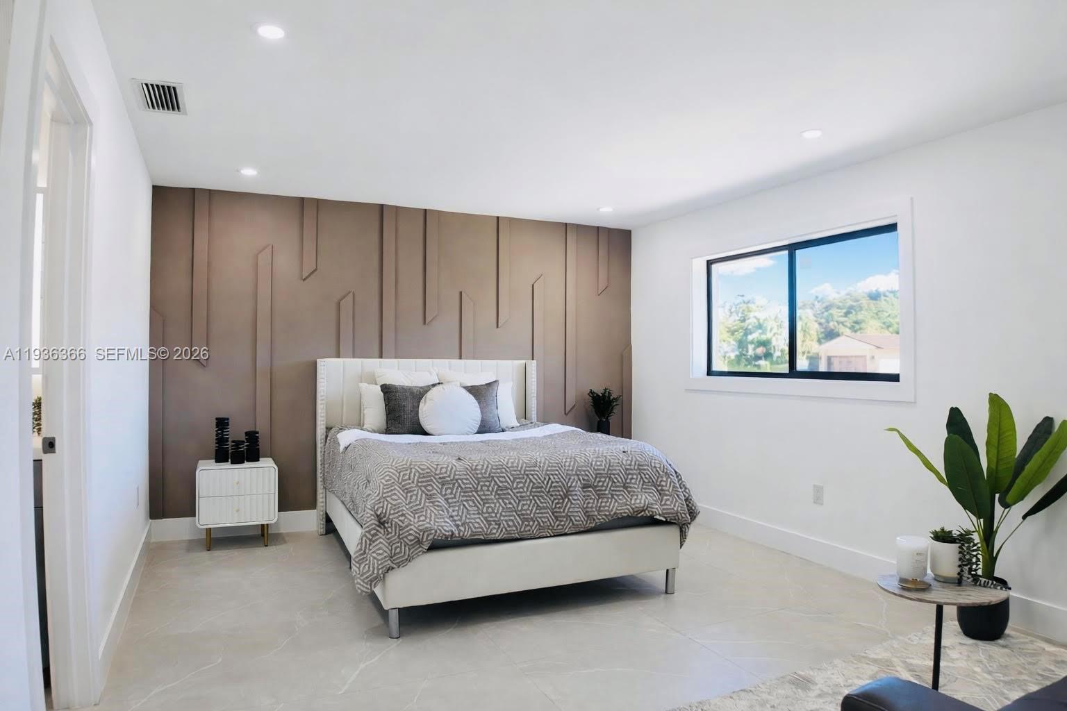 7904 Southwest 139th Court Miami, FL 33183 - Photo 8 of 33 a spacious bedroom with a bed and a potted plant