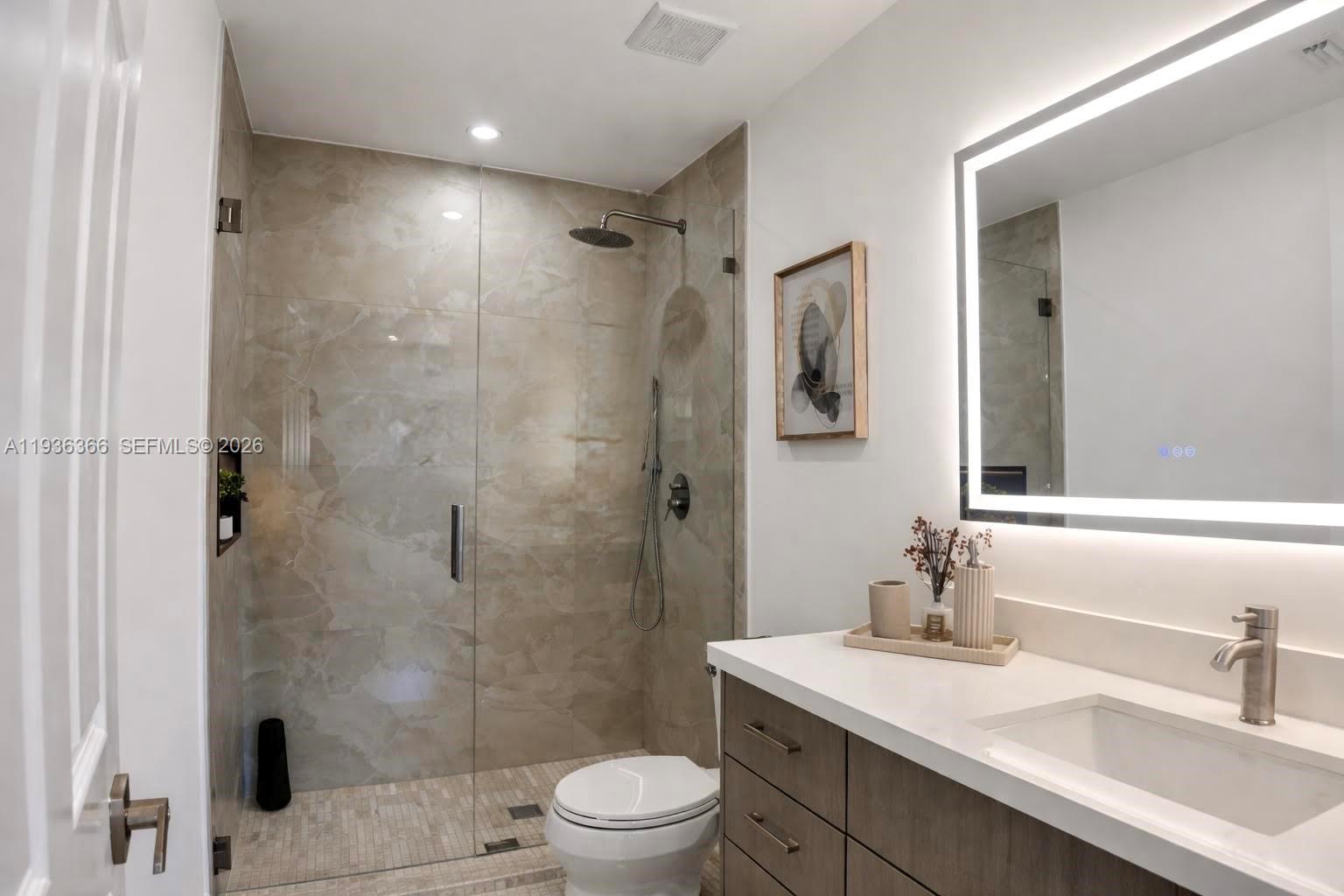 7904 Southwest 139th Court Miami, FL 33183 - Photo 10 of 33 a bathroom with a sink a toilet a mirror and shower