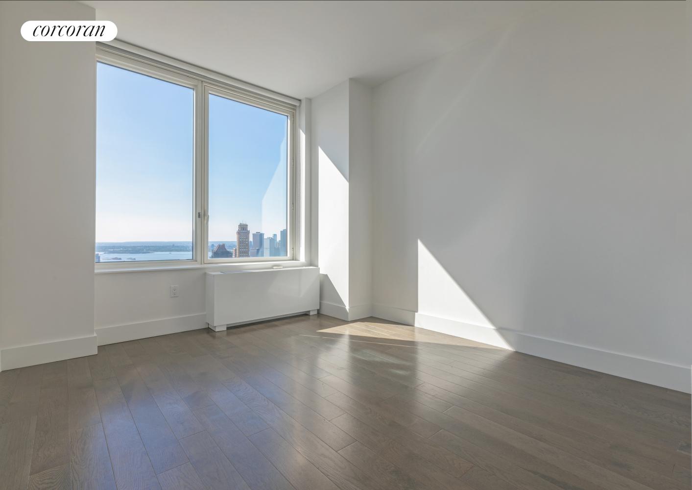 388 Bridge Street, Unit 43H Brooklyn, NY 11201 - Photo 12 of 14 a view of an empty room with wooden floor and a window
