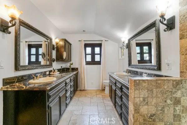 a spacious bathroom with a sink and a mirror