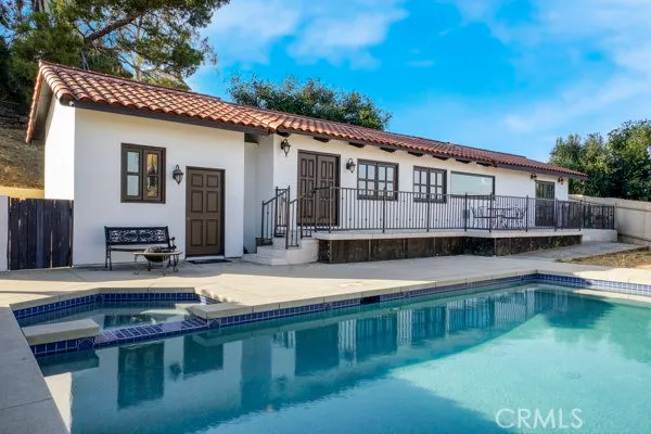 a swimming pool view with a sitting space