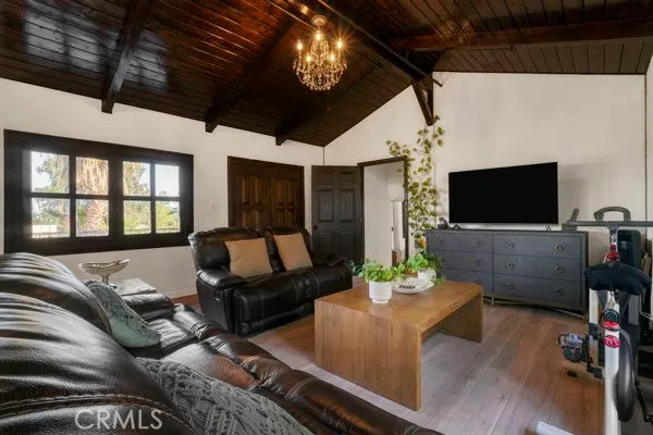 a living room with furniture a flat screen tv and a floor to ceiling window