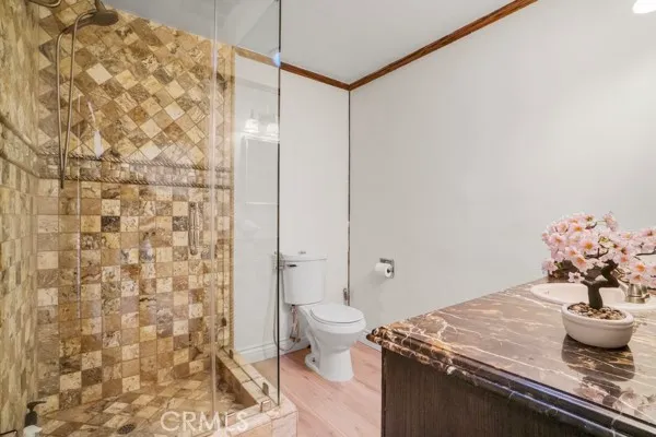 a bathroom with a granite countertop sink toilet and mirror