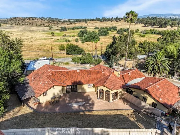 an aerial view of residential houses with outdoor space and ocean view