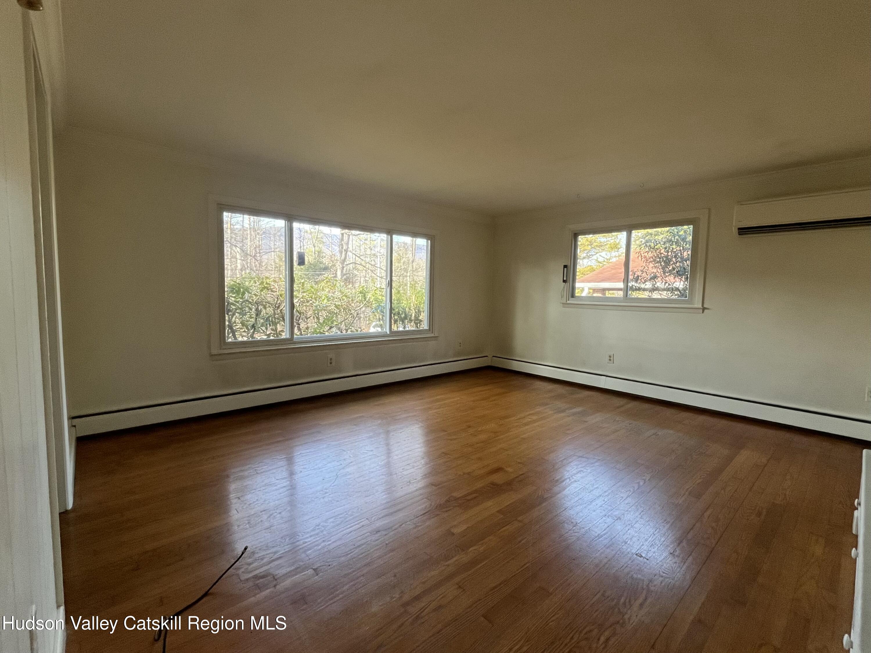 200 Van Vlierden Road Saugerties, NY 12477 - Photo 11 of 29 an empty room with wooden floor and windows