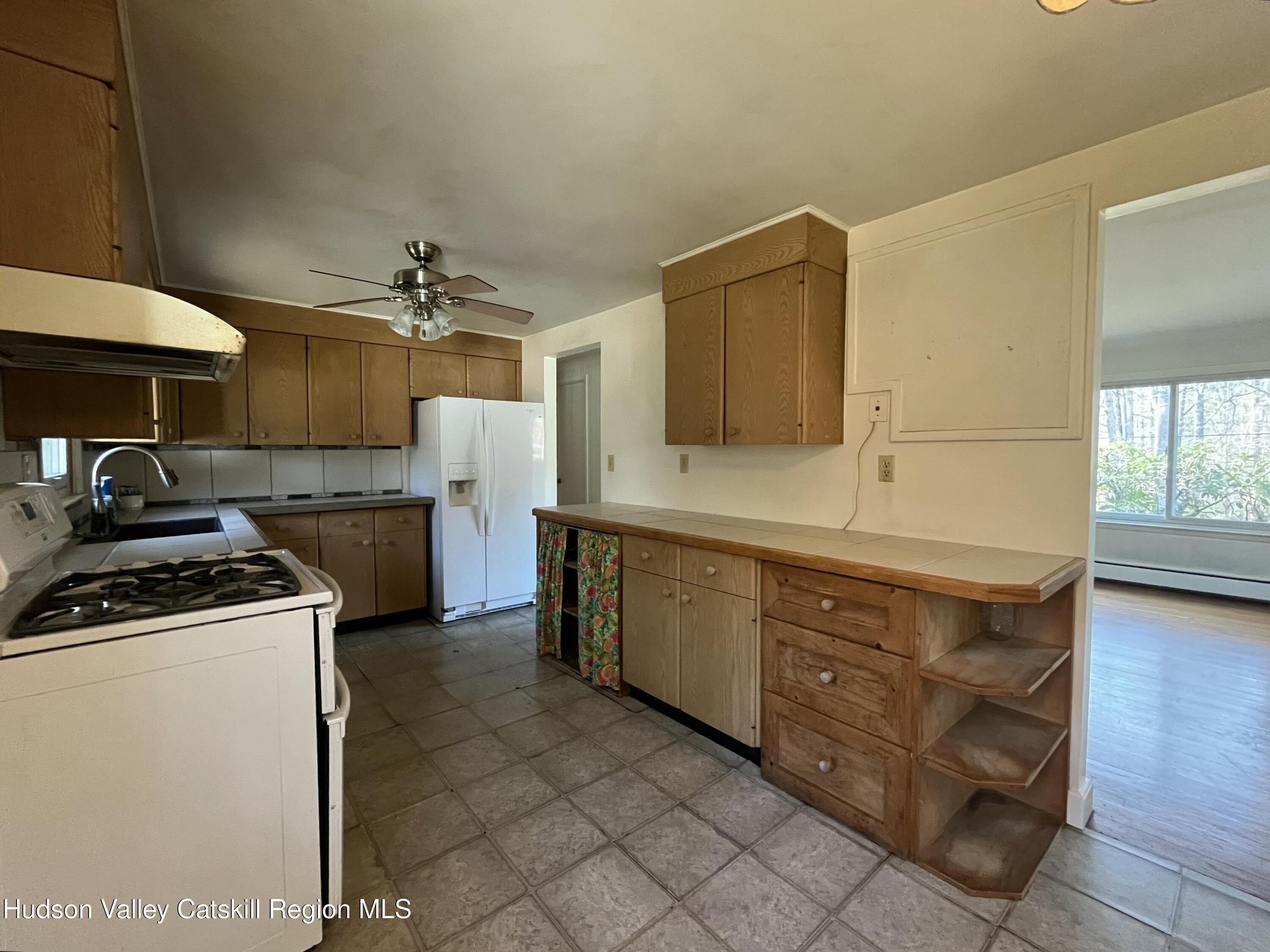 200 Van Vlierden Road Saugerties, NY 12477 - Photo 9 of 29 a kitchen with a stove a sink and a refrigerator