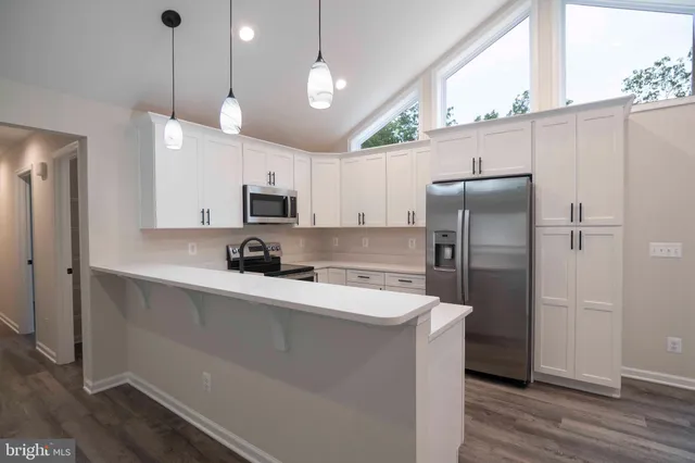 a view of cabinets a wooden floor and windows in a room