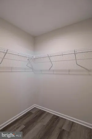 a view of a balcony with wooden floor and potted plants