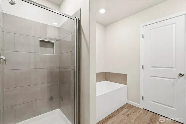 a bathroom with a bathtub and a shower