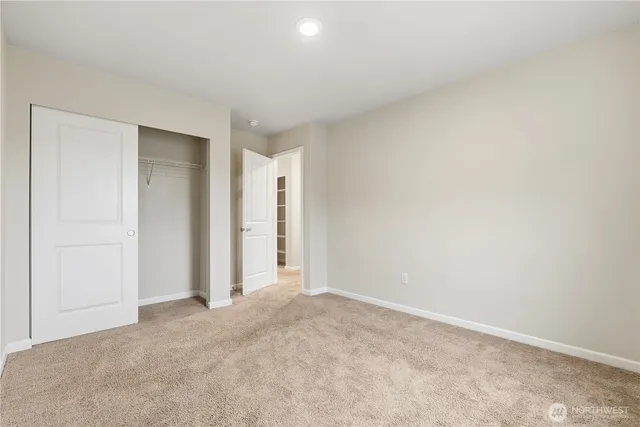 an empty room with closet and bathroom