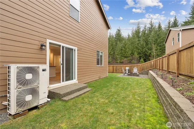 a view of a chair and table in the backyard
