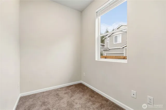 a view of a small space with wooden floor and a window