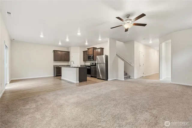 a view of a kitchen with a sink and stainless steel appliances