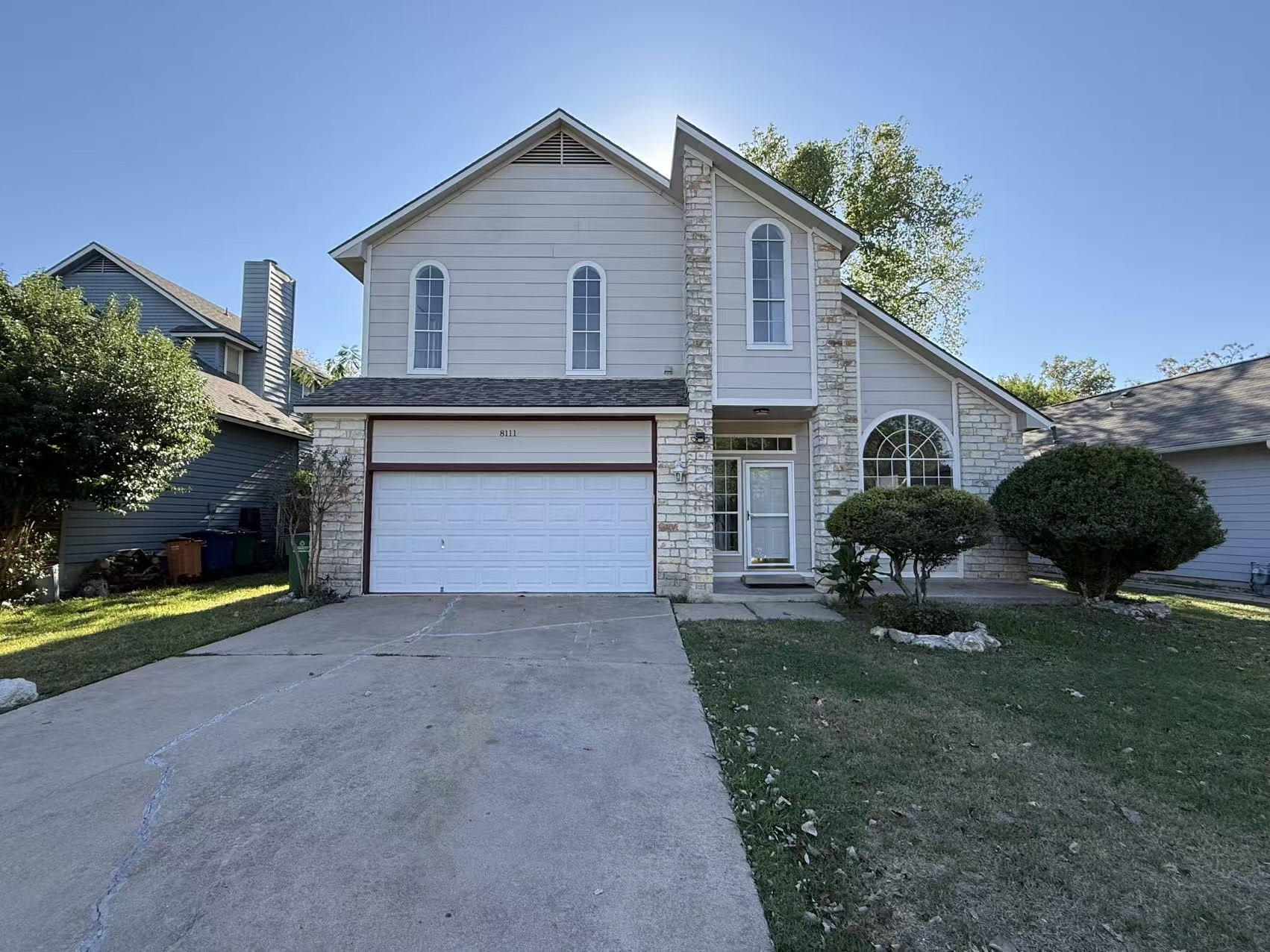 8111 Matchlock Cove Austin, TX 78729 - Photo 28 of 31 a view of a house with a yard and a garage