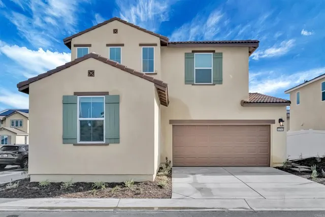 a front view of a house with garage