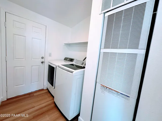 a view of a storage and utility room with washer and dryer