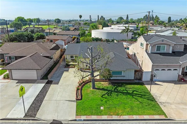 an aerial view of a house with garden space and street view