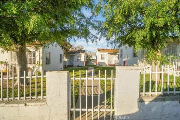a view of a house with a wooden fence