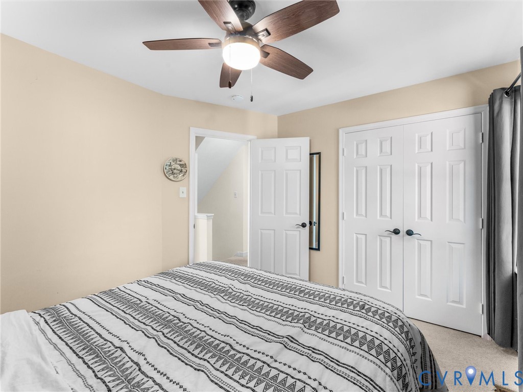 524 Glenmeadow Road Midlothian, VA 23114 - Photo 41 of 64 a bedroom with a large bed and a chandelier