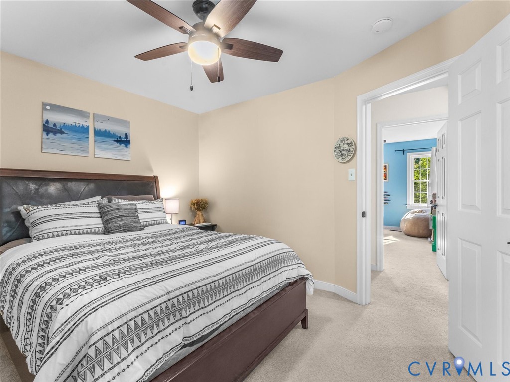 524 Glenmeadow Road Midlothian, VA 23114 - Photo 42 of 64 a bedroom with a bed and a chandelier