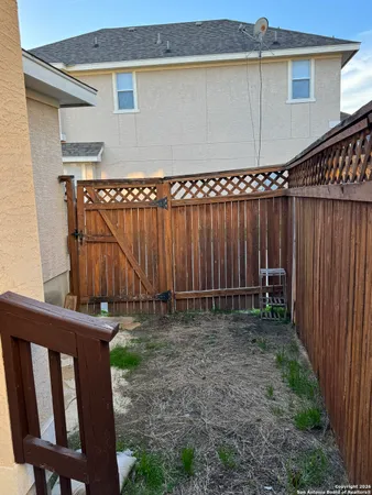 a backyard of a house with lawn chairs