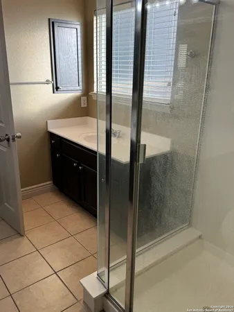 a bathroom with a mirror and a shower