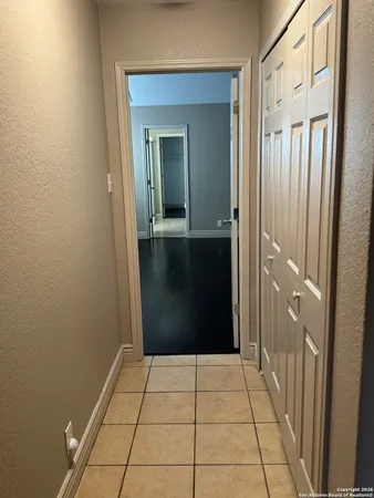 a bathroom with a toilet a sink a mirror and vanity