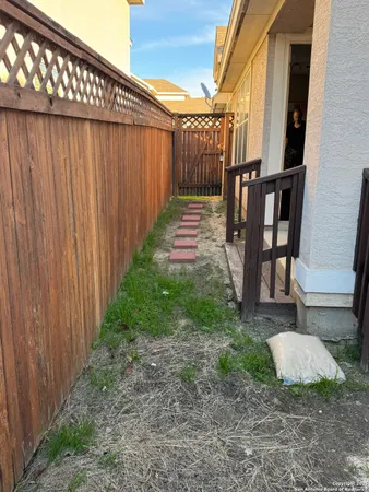 a view of a backyard with wooden fence