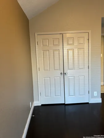 an empty room with wooden floor
