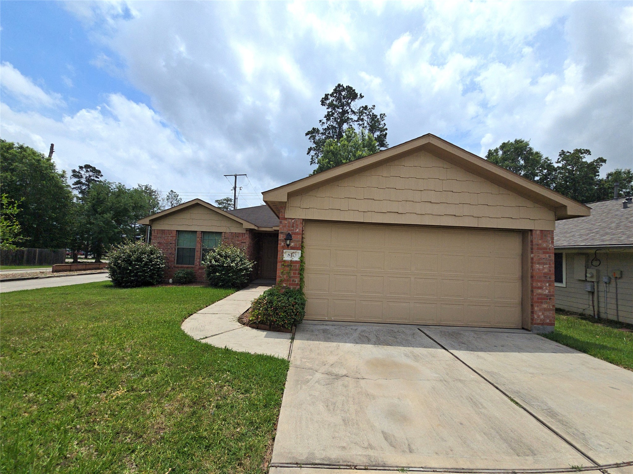 810 Lightningbug Lane Conroe, TX 77301 - Photo 22 of 27 a front view of a house with a yard and garage
