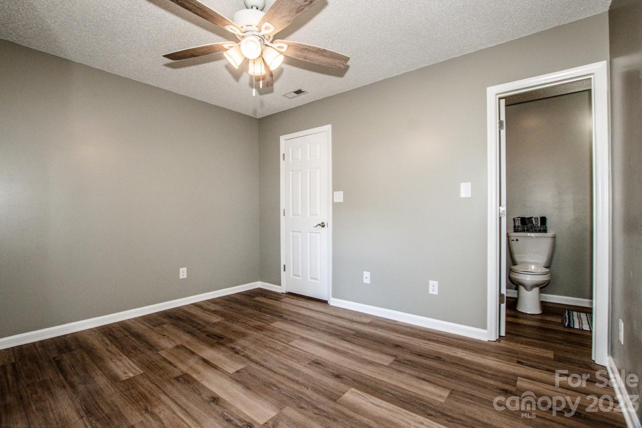 179 Isle Of Pines Road Mooresville, NC 28117 - Photo 11 of 25 a view of a livingroom with a chandelier fan and a bathroom