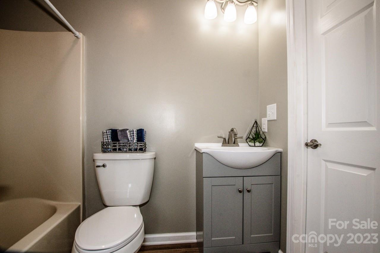 179 Isle Of Pines Road Mooresville, NC 28117 - Photo 12 of 25 a bathroom with a toilet sink and mirror