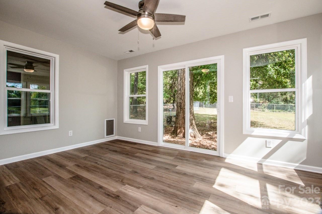179 Isle Of Pines Road Mooresville, NC 28117 - Photo 14 of 25 a view of an empty room with a window and wooden floor