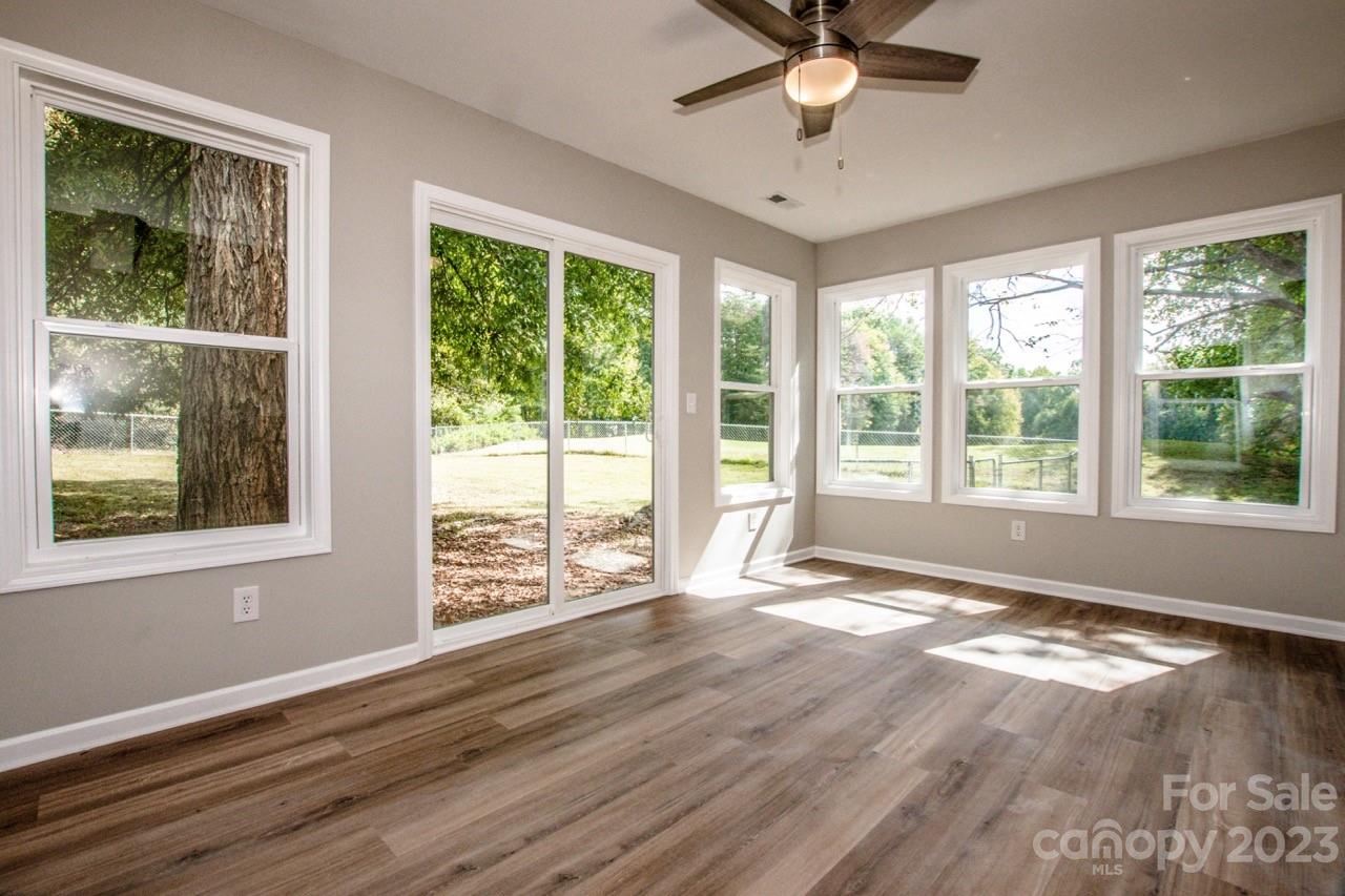 179 Isle Of Pines Road Mooresville, NC 28117 - Photo 15 of 25 a view of an empty room with a window and wooden floor