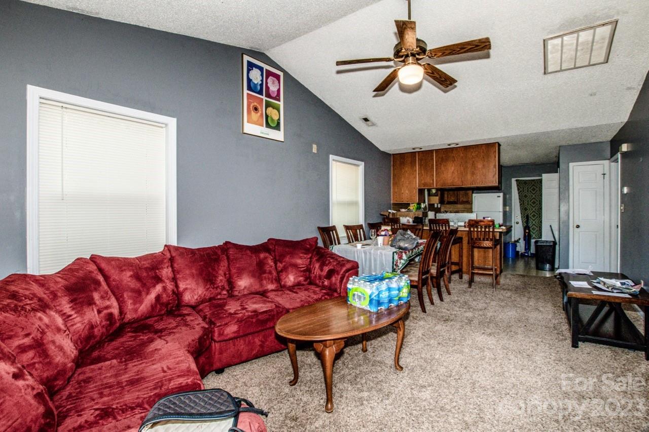 179 Isle Of Pines Road Mooresville, NC 28117 - Photo 20 of 25 a living room with furniture kitchen view and a window