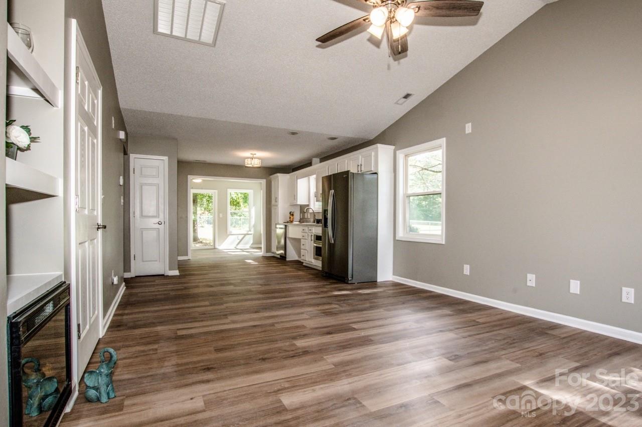 179 Isle Of Pines Road Mooresville, NC 28117 - Photo 6 of 25 a view of an empty room with window and wooden floor
