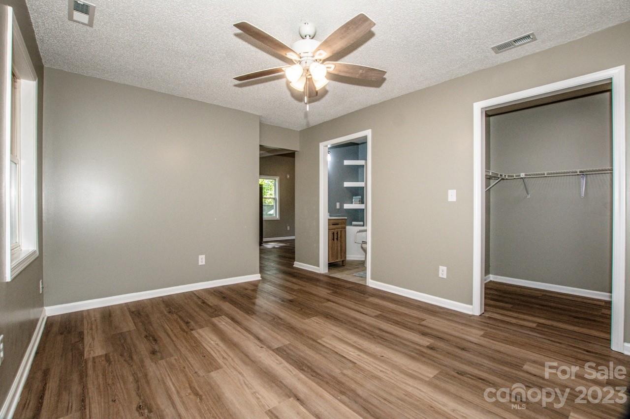 179 Isle Of Pines Road Mooresville, NC 28117 - Photo 7 of 25 wooden floor in an empty room with a window