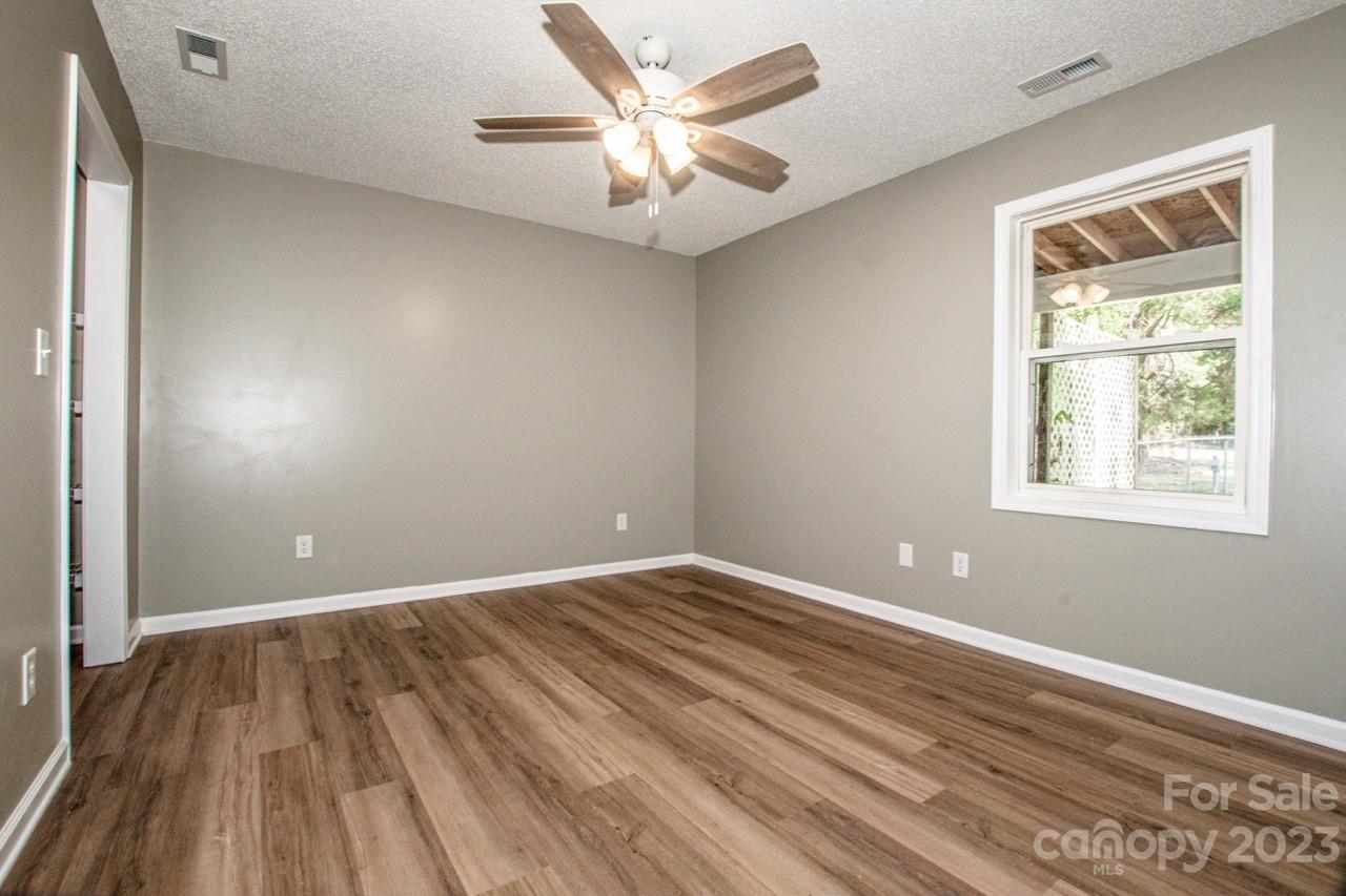 179 Isle Of Pines Road Mooresville, NC 28117 - Photo 8 of 25 wooden floor in an empty room with a window