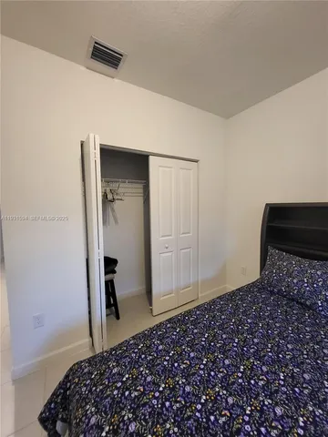 a bedroom with a bed and a walk in closet