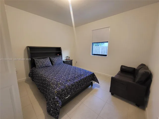 a bedroom with bed and a couch