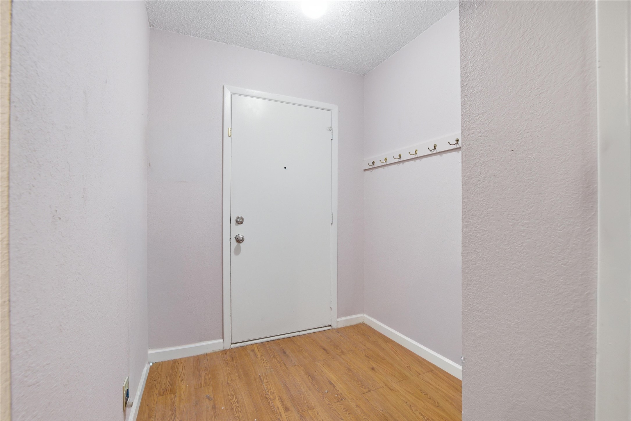2000 Magazine Street Austin, TX 78727 - Photo 3 of 30 A welcoming entryway offers durable hardwood flooring, ideal for everyday use.