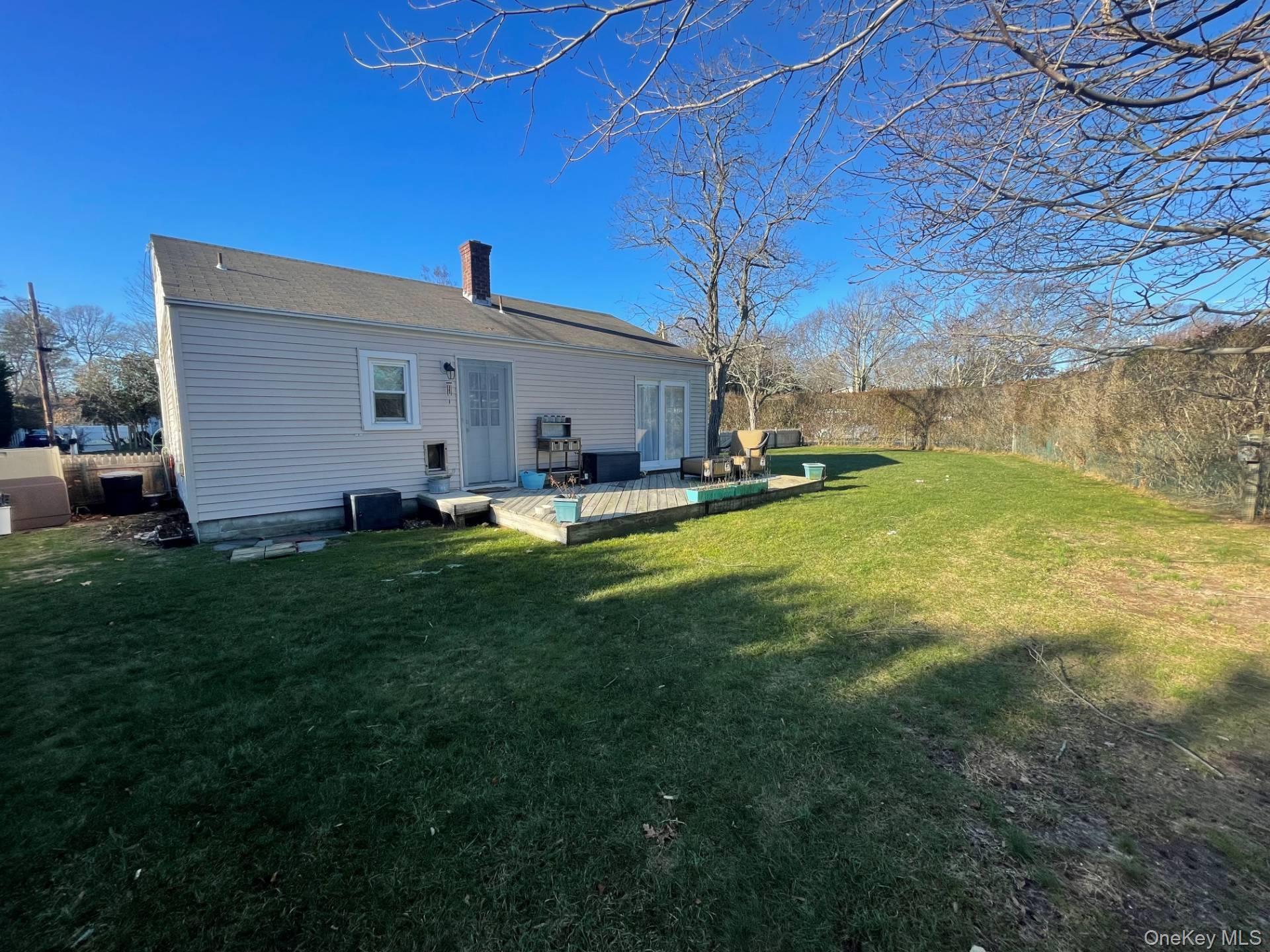 30 Maple Street Westhampton Beach, NY 11978 - Photo 13 of 14 Back of House Featuring a Wooden Deck & Yard
